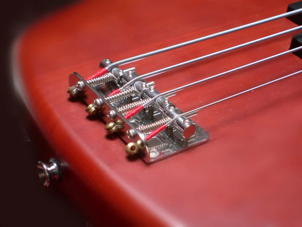 Red bass guitar body, bridge and strings