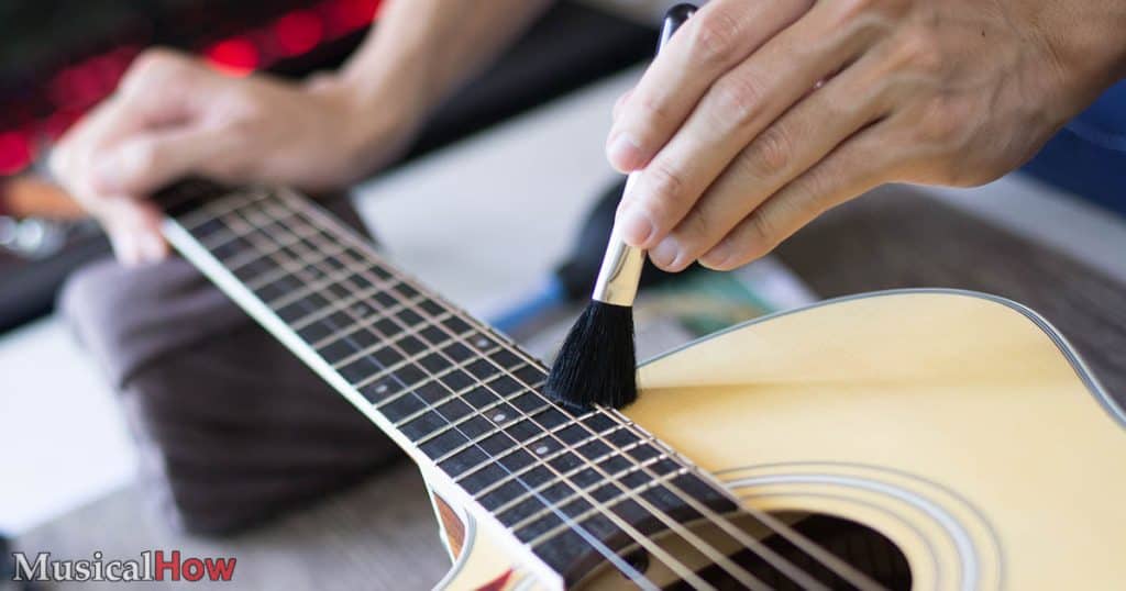 Cleaning a guitar with a brush